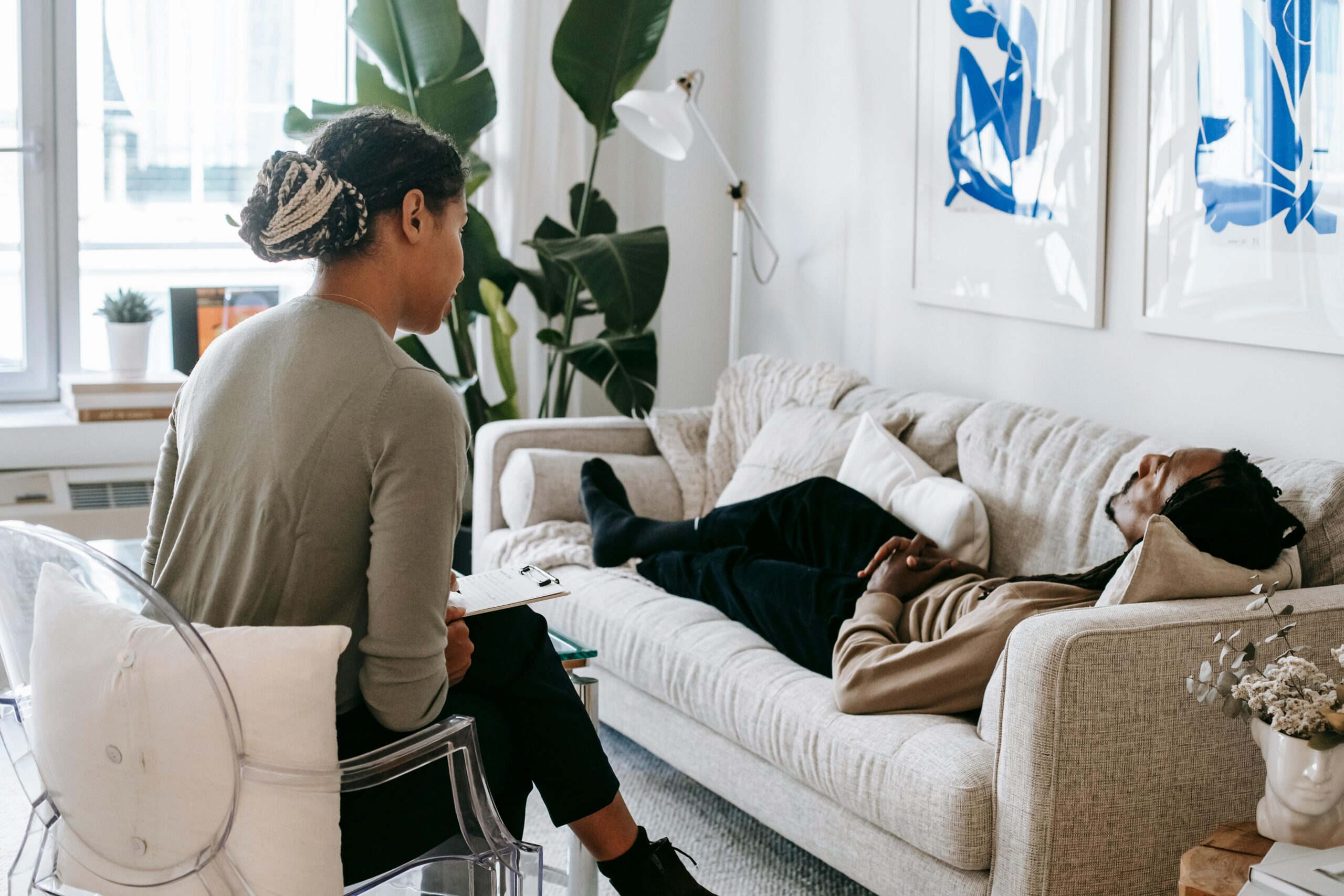 Man lying down on couch talking to professional guide